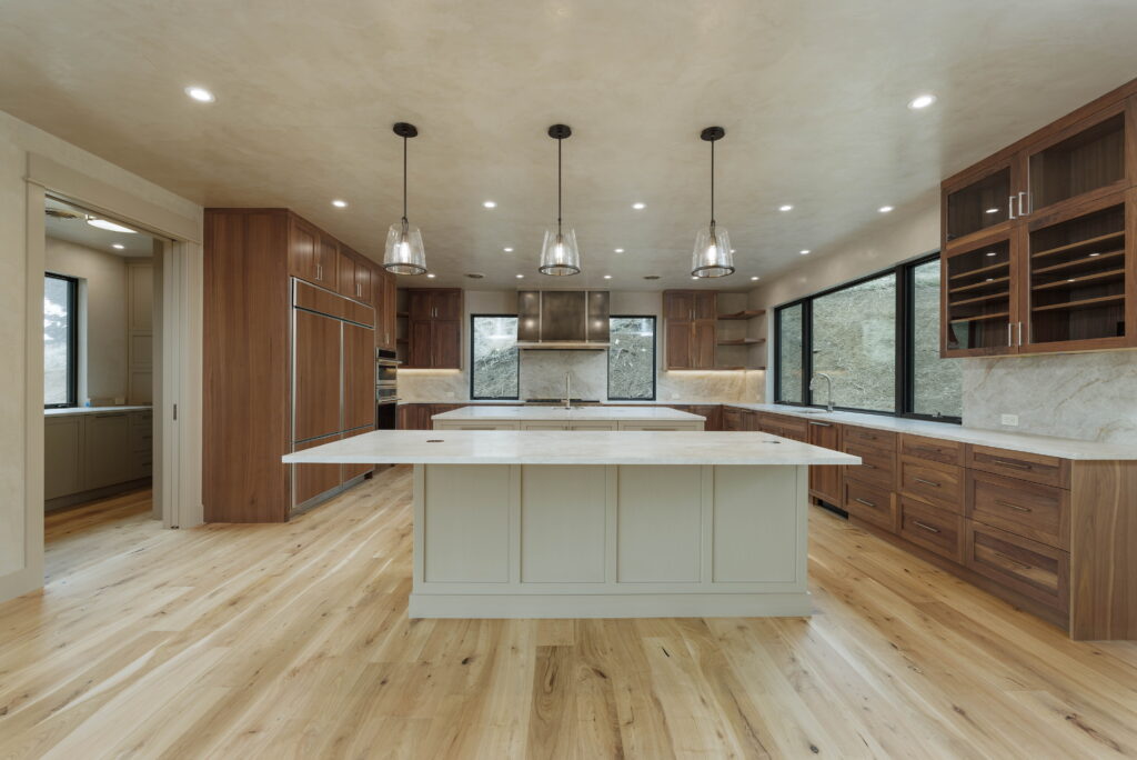 Modern open floor plan showing light hardwood floors and dark wood furniture contrast